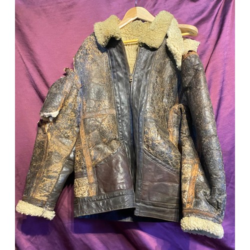 719 - A well-worn WWII flying jacket, more or less complete with tears to shoulder and elbow / All lots ar... 