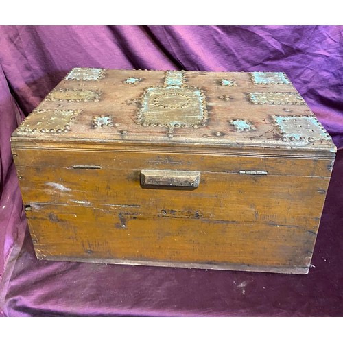 693 - A middle eastern teak campaign chest, with beaten brass bounds and studded structure / All lots are ... 