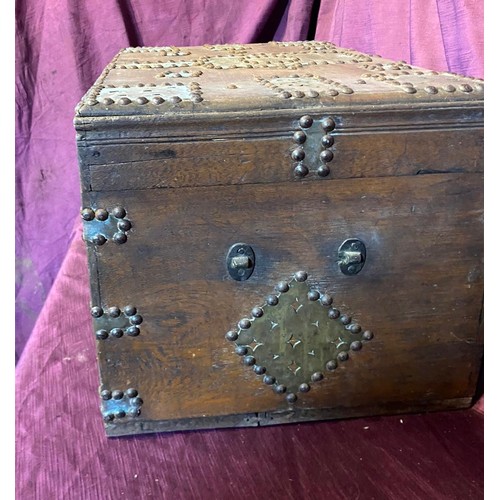 693 - A middle eastern teak campaign chest, with beaten brass bounds and studded structure / All lots are ... 