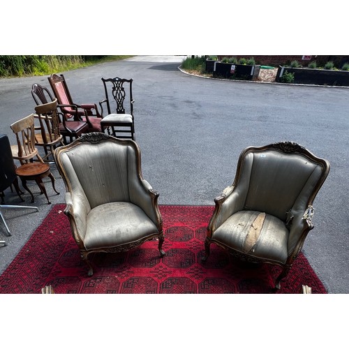 514 - A pair of 20th century continental salon armchairs, with original silk upholstery, carved wood and g... 