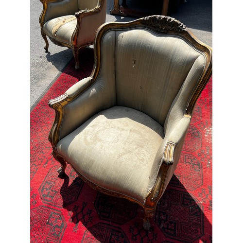 514 - A pair of 20th century continental salon armchairs, with original silk upholstery, carved wood and g... 