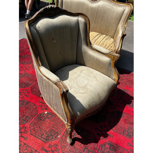 514 - A pair of 20th century continental salon armchairs, with original silk upholstery, carved wood and g... 