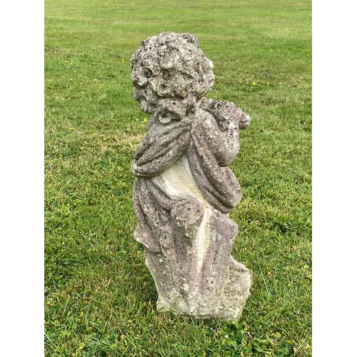 939 - A 20th century composition stone cherub statue blowing a pipe / All lots are located at The Barn, Ha... 