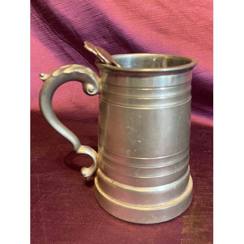 868 - One pewter tankard and five spoons. The pewter tankard showcases a classic design with scroll handle... 