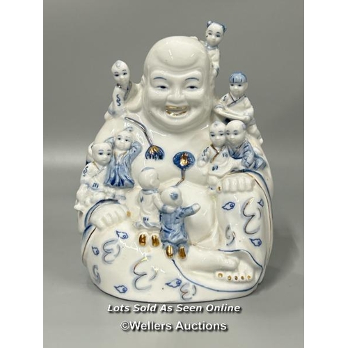 11 - A porcelain figure of Buddha surrounded by nine children by Vmart, 21cm high / AN4