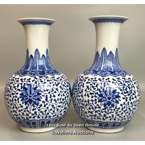 6 - A pair of Chinese blue & white Qianglong-style lotus design bottle vases, one slightly taller than t... 