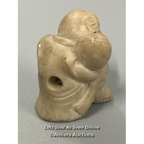 20 - Two carved tagua nut netsukes one in the form of a mother and child, 4.5cm high, the other in the fo... 