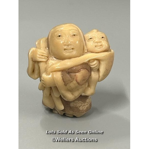 20 - Two carved tagua nut netsukes one in the form of a mother and child, 4.5cm high, the other in the fo... 