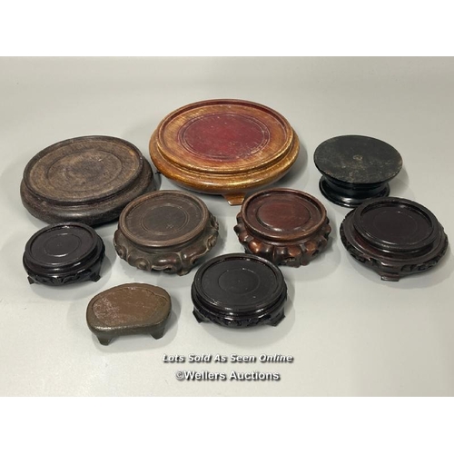 26 - Nine assorted wooden stands, largest 19cm diameter / AN5