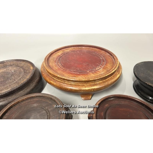 26 - Nine assorted wooden stands, largest 19cm diameter / AN5