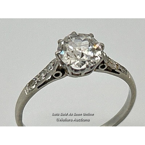 305 - A solitaire diamond ring with an old European cut diamond claw set between diamond set shoulders. Es... 