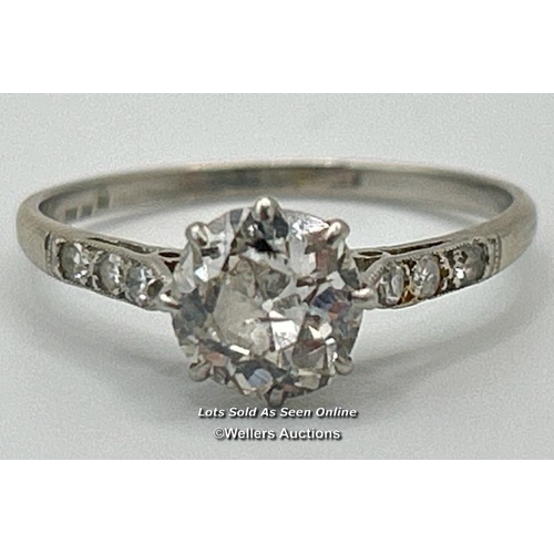 305 - A solitaire diamond ring with an old European cut diamond claw set between diamond set shoulders. Es... 