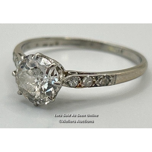 305 - A solitaire diamond ring with an old European cut diamond claw set between diamond set shoulders. Es... 