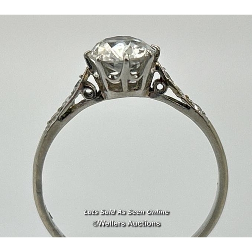 305 - A solitaire diamond ring with an old European cut diamond claw set between diamond set shoulders. Es... 