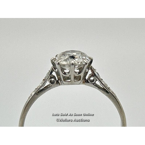 305 - A solitaire diamond ring with an old European cut diamond claw set between diamond set shoulders. Es... 