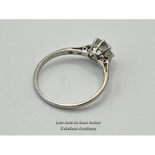 305 - A solitaire diamond ring with an old European cut diamond claw set between diamond set shoulders. Es... 