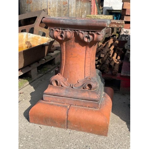 688 - A terracotta plinth with scroll design, 59cm high