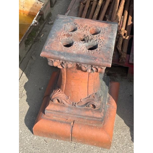 688 - A terracotta plinth with scroll design, 59cm high