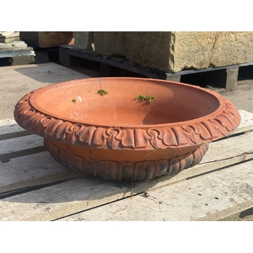 689 - A terracotta bowl with detailed roll top edging, 55cm diameter