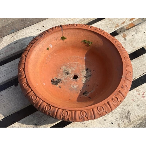 689 - A terracotta bowl with detailed roll top edging, 55cm diameter