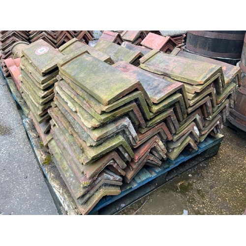 76 - Pallet of approx. x100 red ridge roof tiles, measures approx. 50cm l