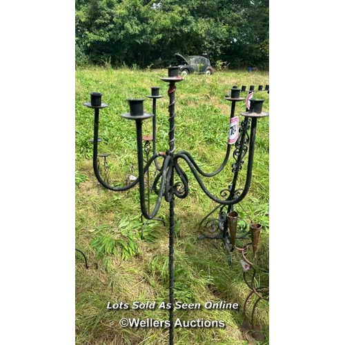 184 - Six arm wrought iron candle holder stand, 146cm (h) / Please bring equipment and labour to assist wi... 