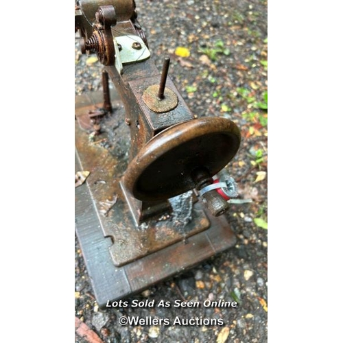 531 - A vintage sewing machine on wooden base / Please bring equipment and labour to assist with removal o... 