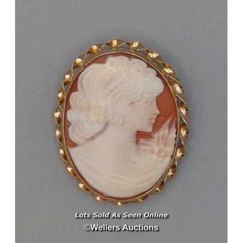 308 - Two modern oval shell cameo brooches, the first mounted in 9ct gold with twisted wire border and rol... 