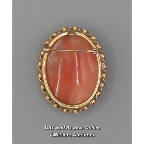 308 - Two modern oval shell cameo brooches, the first mounted in 9ct gold with twisted wire border and rol... 