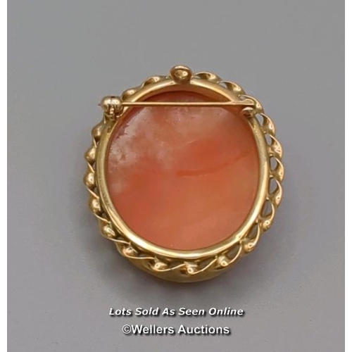 308 - Two modern oval shell cameo brooches, the first mounted in 9ct gold with twisted wire border and rol... 