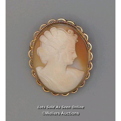 308 - Two modern oval shell cameo brooches, the first mounted in 9ct gold with twisted wire border and rol... 