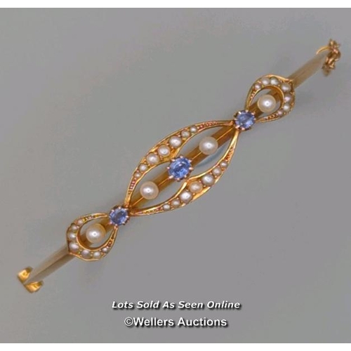 309 - Antique bangle of hinged design, the top supporting three oval sapphires and four pearls within a bo... 