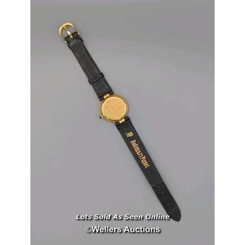 310 - Audemars Piguet. A ladies gold 1970's wristwatch, the black signed dial set with 56 round brilliant ... 