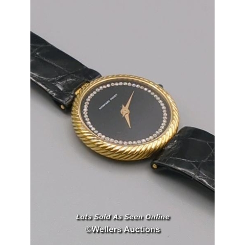 310 - Audemars Piguet. A ladies gold 1970's wristwatch, the black signed dial set with 56 round brilliant ... 