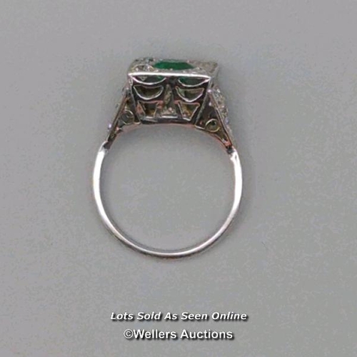 311 - Antique ring of Art Deco design, the central cushion cut emerald surrounded by old cut diamonds pave... 