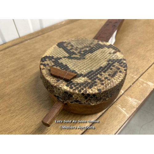 37 - African snake skin three string instrument, only one string present, 82cm long / container no: s207 ... 