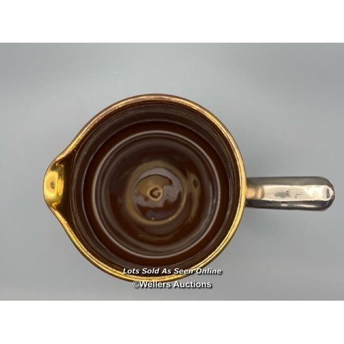 62 - A part unusual pottery tea & coffee service with metallic coating. The interior of the sugar bowl te... 