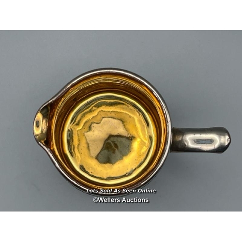 62 - A part unusual pottery tea & coffee service with metallic coating. The interior of the sugar bowl te... 