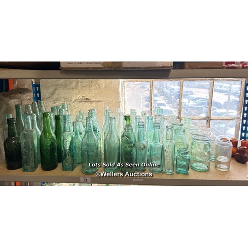 73 - A very large collection of assorted vintage glass bottles and jars including R Whites, Bovril, Carlt... 