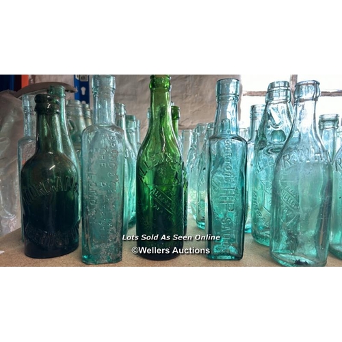 73 - A very large collection of assorted vintage glass bottles and jars including R Whites, Bovril, Carlt... 