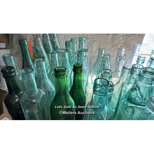 73 - A very large collection of assorted vintage glass bottles and jars including R Whites, Bovril, Carlt... 