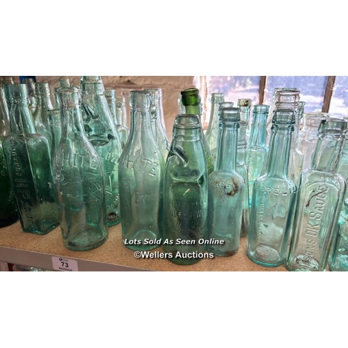 73 - A very large collection of assorted vintage glass bottles and jars including R Whites, Bovril, Carlt... 