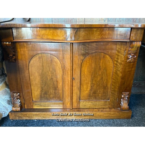 86 - Antique bow front cabinet with one drawer over two doors and carved finials, with key but lock not w... 