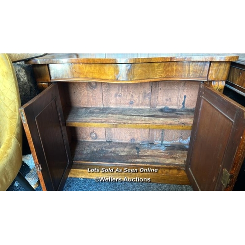 86 - Antique bow front cabinet with one drawer over two doors and carved finials, with key but lock not w... 