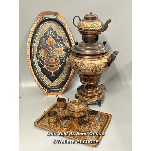 132 - A highly decorated copper samovar, teapot, trays, bowl and cup surrounds, samovar and teapot 49cm hi... 