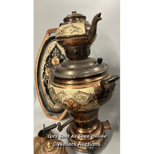 132 - A highly decorated copper samovar, teapot, trays, bowl and cup surrounds, samovar and teapot 49cm hi... 