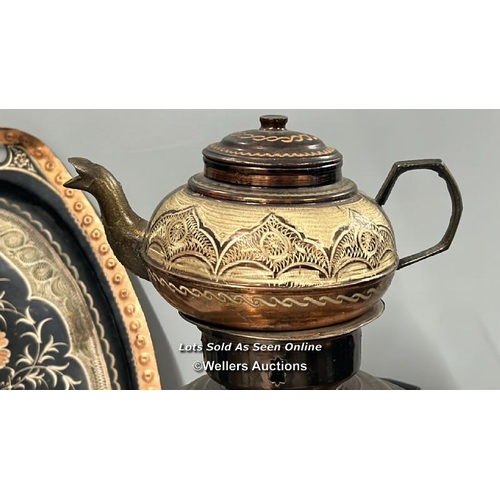 132 - A highly decorated copper samovar, teapot, trays, bowl and cup surrounds, samovar and teapot 49cm hi... 