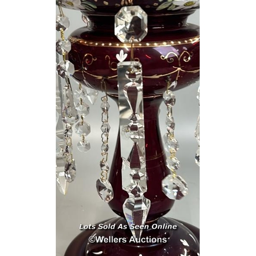 138 - A victorian ruby red mantle lustre with crystal drops, and some spares, 35.5cm high / AN19