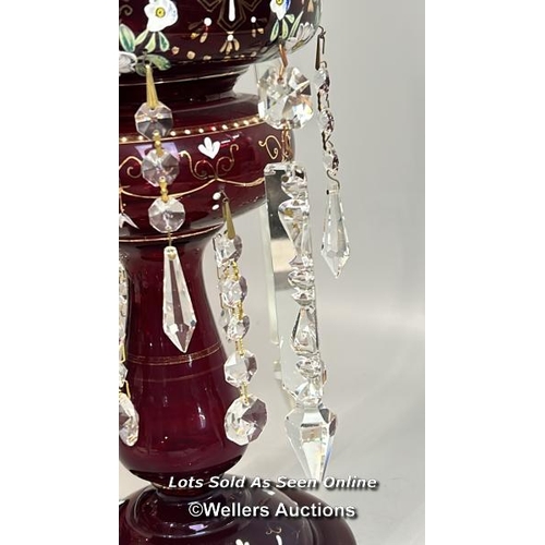 138 - A victorian ruby red mantle lustre with crystal drops, and some spares, 35.5cm high / AN19