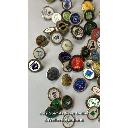 152 - A large collection of Golf tee markers including The Open - St Andrews 2005 / AN24